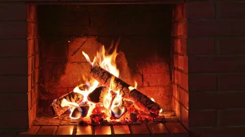 Burning logs and embers in a red brick fireplace in a country cottage Stock Footage 163988646