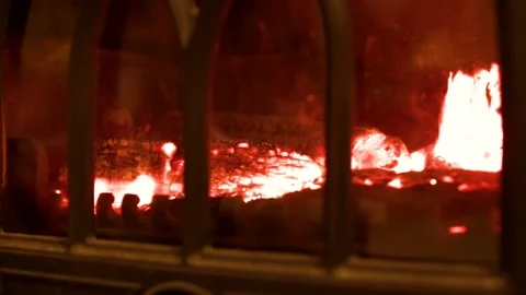 Burning Logs and Glowing Embers in a Cast Iron Wood Stove Stock Footage 341373688