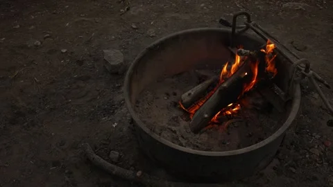 Burning logs create bright flames inside metal fire pit outdoors Stock Footage 342303086