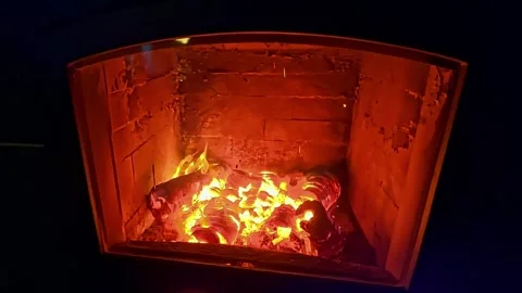 Burning logs glowing inside a brick oven fireplace Stock Footage 323315073