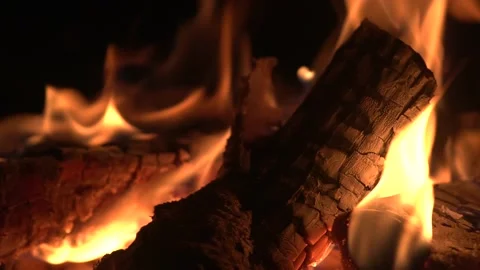 Burning logs in a stove, fireplace or bonfire at night Stock Footage 134685115