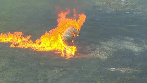 A burning man runs out of a fire, clothes are burning on a stuntman, firefighter Stockbeeldmateriaal 81239622