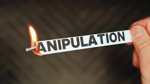 Burning “manipulation” label held by hand, symbolizing healthy boundaries Stock Footage 333649764