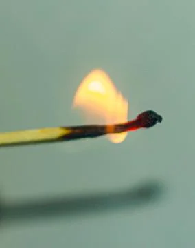 Burning match on abstract background Stock-Fotos