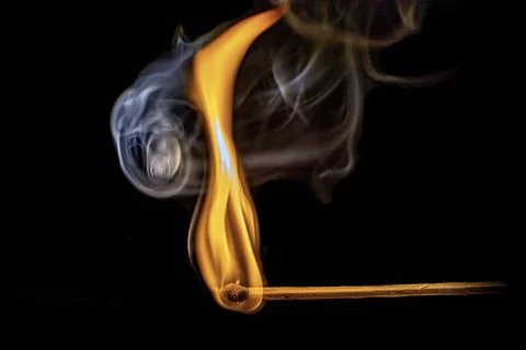 Burning match on a black background, close-up Stock Photos