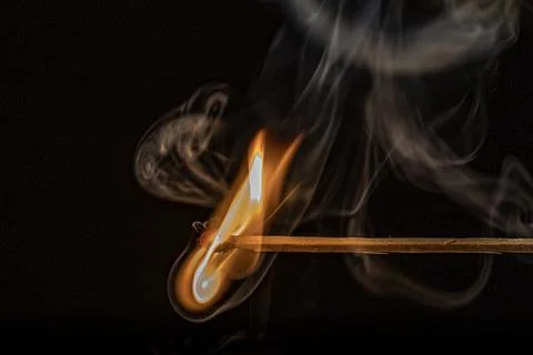 Burning match on a black background, close-up Stock Photos