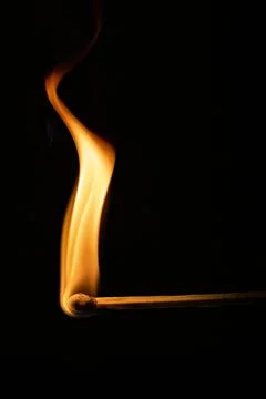 Burning match on a black background, close-up Stock Photos