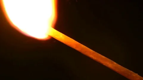 Burning match on a black background Видео 81449782