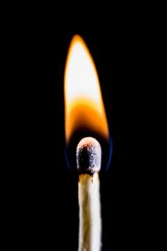 Burning match, on a black background Stock Photos