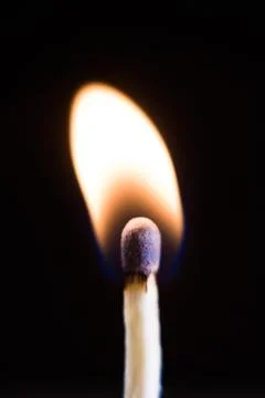 Burning match, on a black background Stock Photos