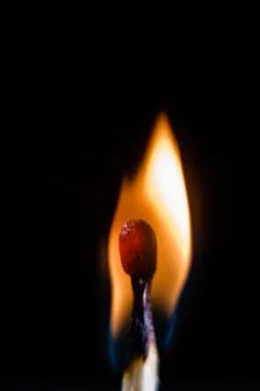 Burning match, on a black background Stock Photos