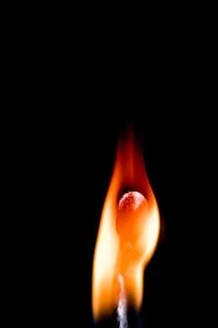 Burning match, on a black background Stock Photos