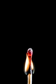 Burning match, on a black background Stock Photos