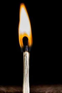 Burning match, on a black background Stock Photos