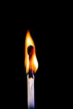 Burning match, on a black background Stock Photos