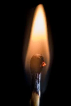 Burning match, on a black background Stock Photos