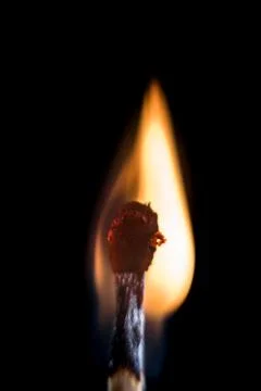 Burning match, on a black background Stock Photos