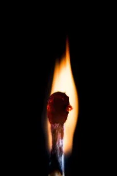 Burning match, on a black background Stock Photos
