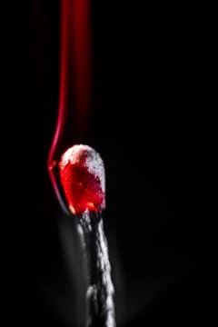 Burning match, on a black background Stock Photos