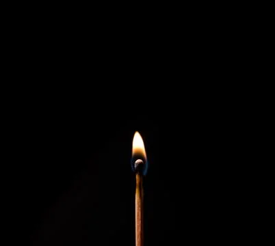 Burning match, on a black background Stock Photos
