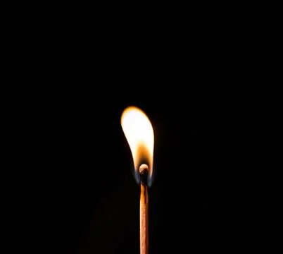 Burning match, on a black background Stock Photos