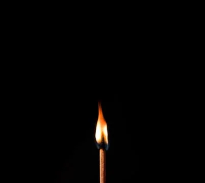 Burning match, on a black background Stock Photos
