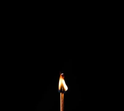 Burning match, on a black background Stock Photos