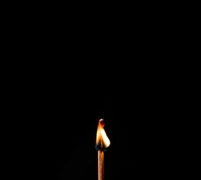 Burning match, on a black background Stock Photos