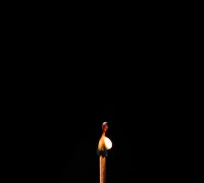 Burning match, on a black background Stock Photos