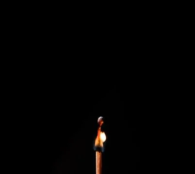 Burning match, on a black background Stock Photos
