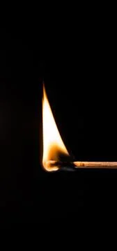 Burning match, on a black background Stock Photos