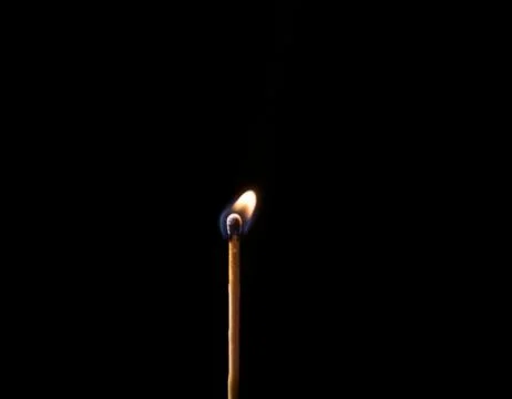 Burning match, on a black background Stock Photos
