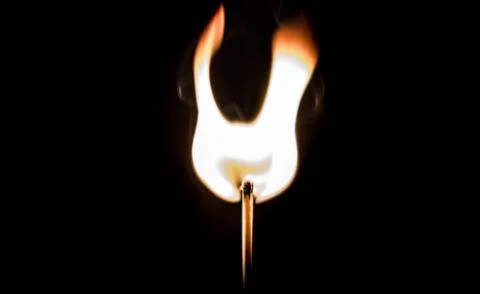 Burning match, on a black background Stock Photos