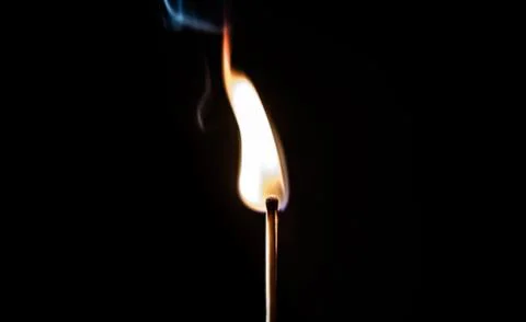 Burning match, on a black background Stock Photos