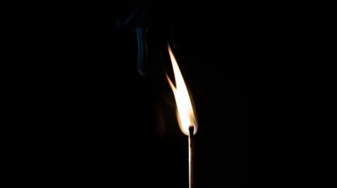 Burning match, on a black background Stock Photos