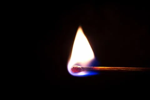 Burning match on a black background Stock Photos