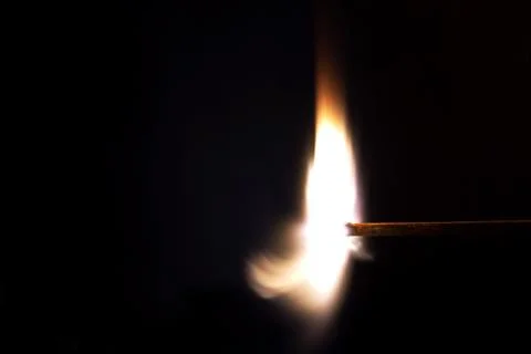 Burning match on a black background Stock Photos