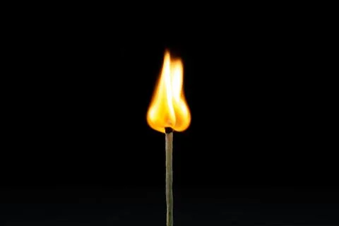 Burning match on a black background.  Stock Photos