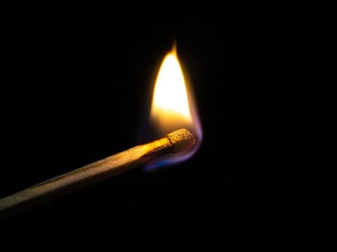 Burning match on black background Stock Photos