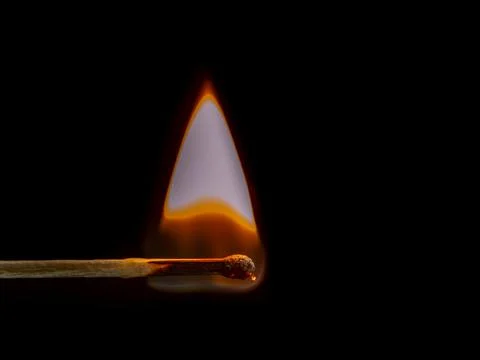 Burning match on black background Stock Photos