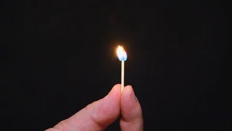 Burning match on a dark background Stock Footage 106627623