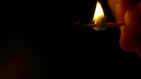 A burning match on a dark background Stock Footage 259268719