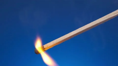 Burning match with the flame on blue background. slow motion HD Stock Footage 150900342