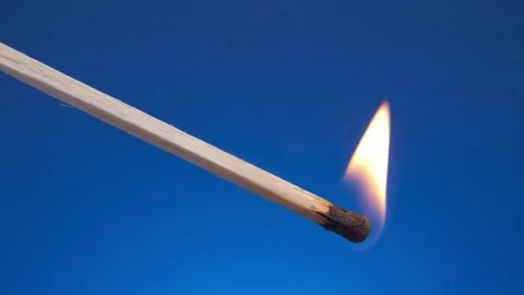 Burning match with the flame on blue background. slow motion HD. Stock Footage 157610258