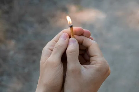 Burning match in hands. Stock Photos