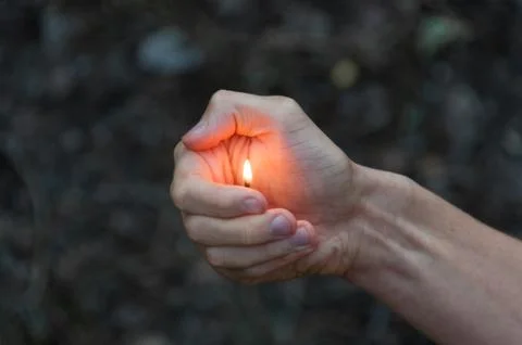 Burning match in hands. Stock Photos