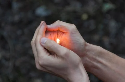 Burning match in hands. Stock Photos
