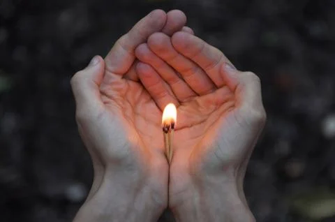 Burning match in hands. Stock Photos
