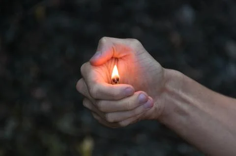 Burning match in hands. Stock Photos