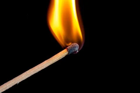 Burning match isolated on black background Stock Photos